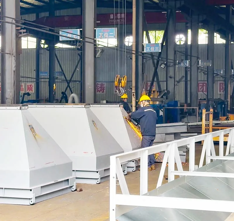 Worker fabricating steel hoppers for concrete batching plants